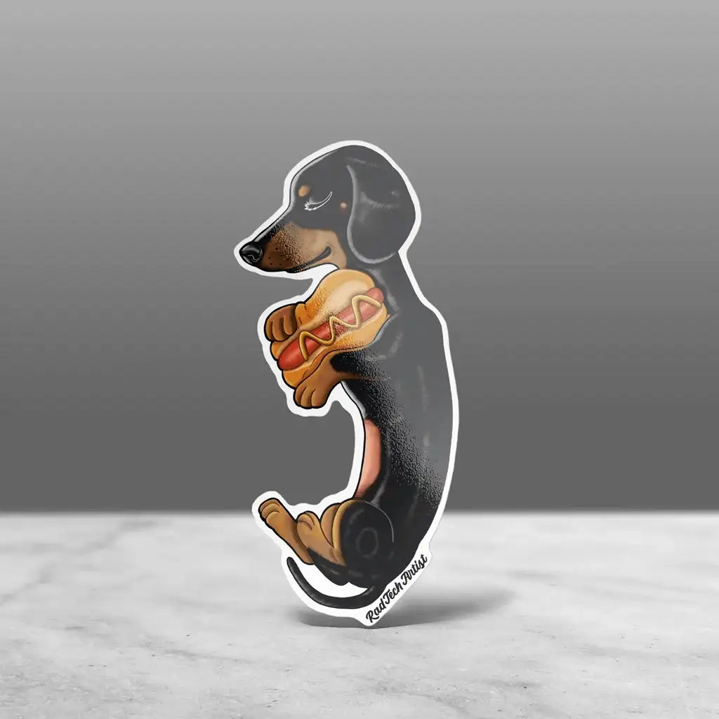 A sticker of a Black and Tan dachshund sleeping and holding a hot dog pillow with a happy expression.