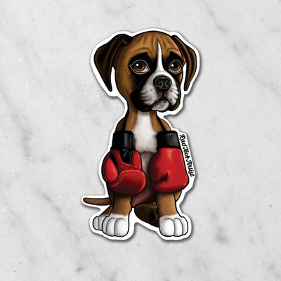 Magnet of a fawn Boxer puppy wearing boxing gloves on a marble background