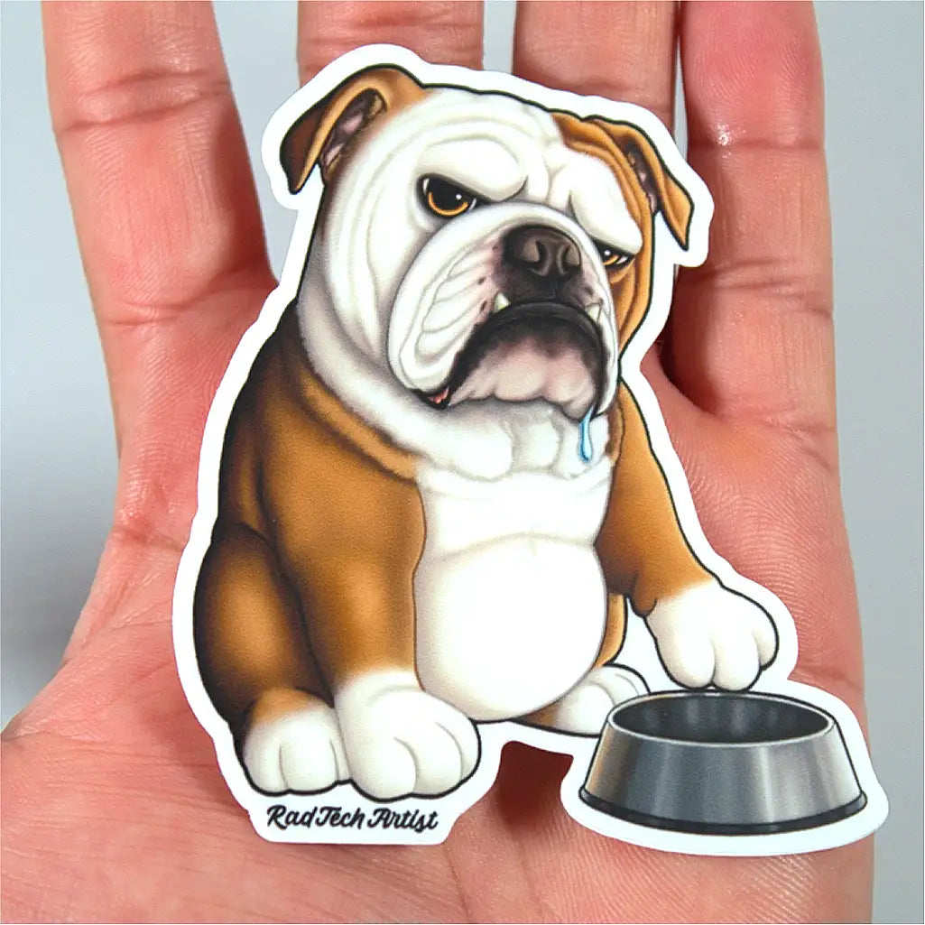 Sticker of a red and white English bulldog held in a hand.