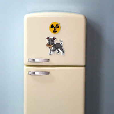 Blue-white Pit Bull dog magnet holding a teddy bear displayed on a beige mini fridge with light blue background.