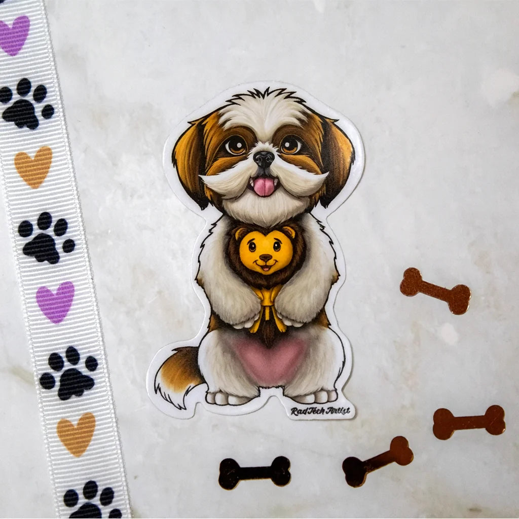 Sticker of a gold and white Shih Tzu holding a plush lion toy, photographed on a marble surface with paw print ribbon and bone-shaped magnets.