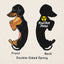 Front and back view of the Dachshund acrylic keychain with epoxy coating, featuring a playful black and tan dachshund holding a hot dog on the front and the Rad Tech Artist logo on the back.