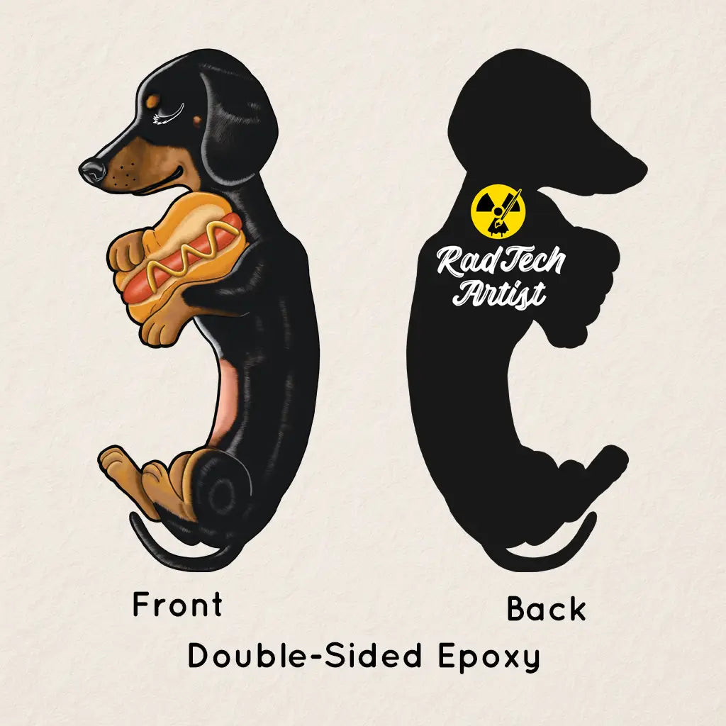 Front and back view of the Dachshund acrylic keychain with epoxy coating, featuring a playful black and tan dachshund holding a hot dog on the front and the Rad Tech Artist logo on the back.