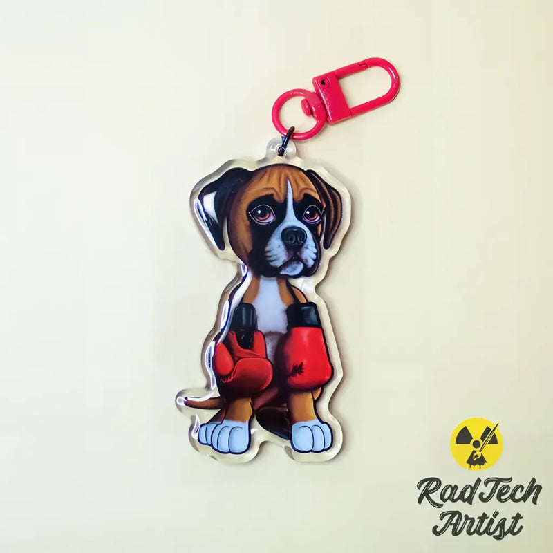 Boxer puppy acrylic keychain with red boxing gloves on a light background