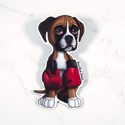 Magnet of a fawn boxer puppy wearing red boxing gloves on a white background 