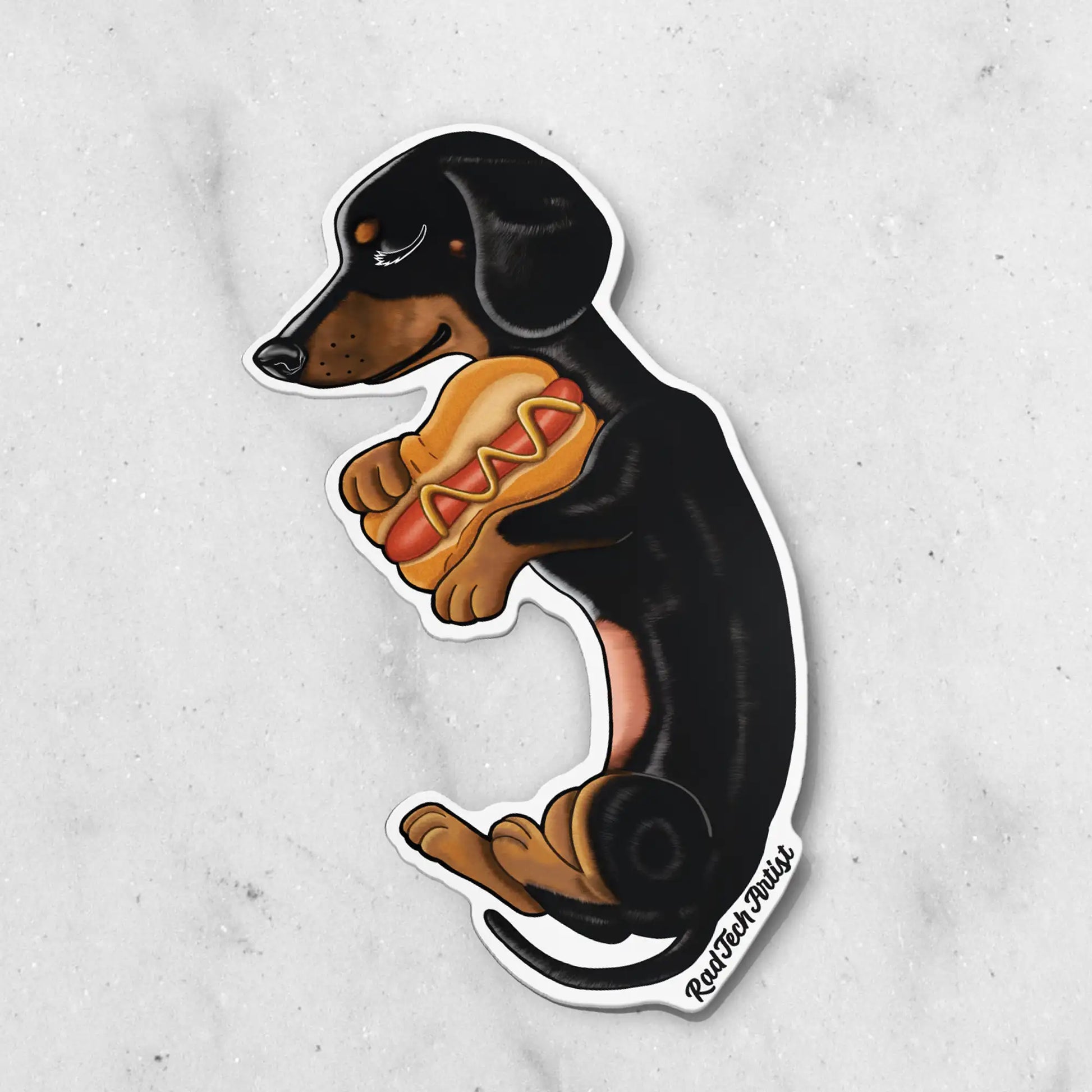 Sticker of a black and tan dachshund with a hot dog on a gray background