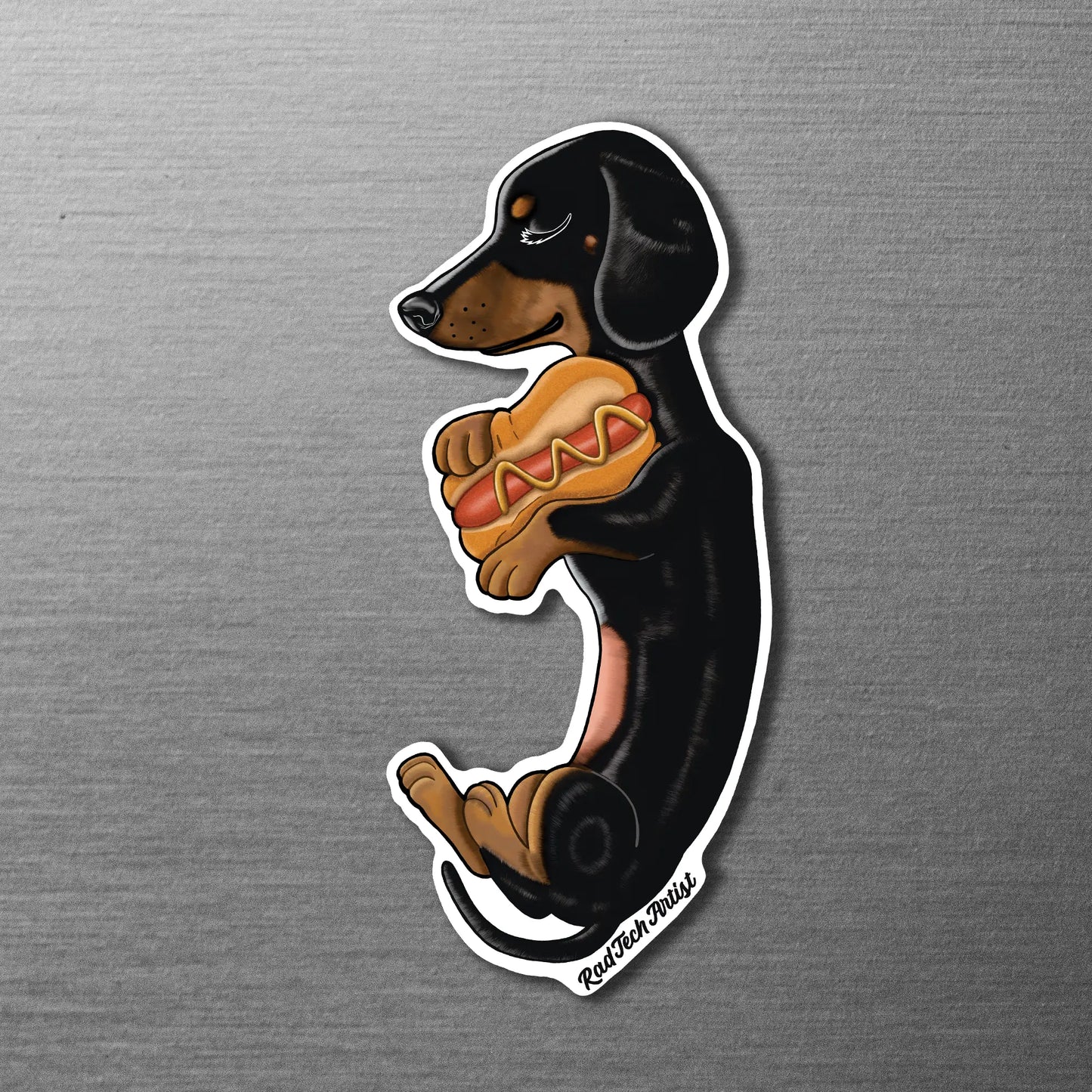 Magnet of a black and tan dachshund with a hot dog on a metallic surface
