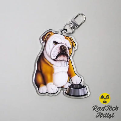 English Bulldog acrylic keychain featuring a red and white bulldog sitting beside a silver food bowl, with glossy epoxy finish and silver lobster clasp.