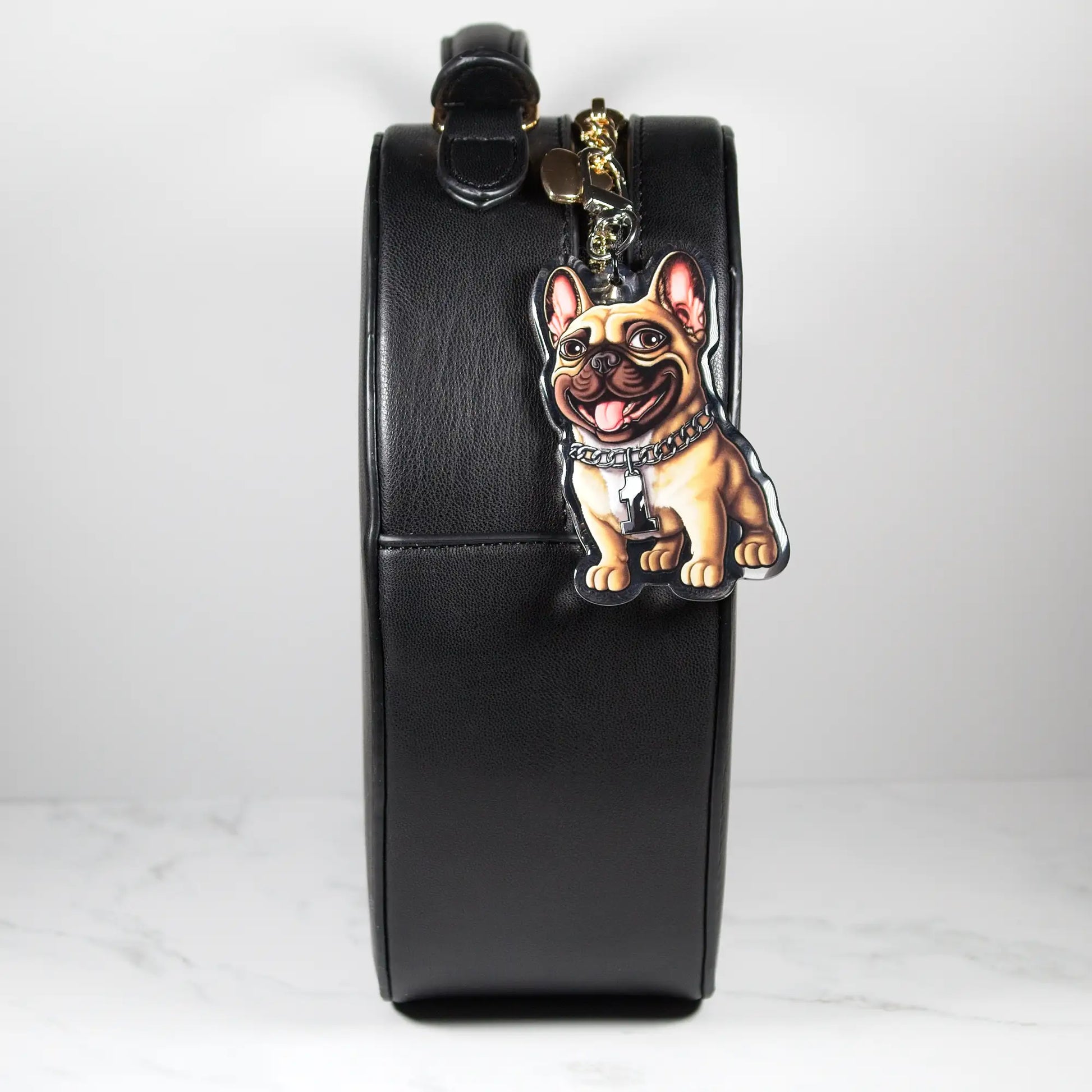 Black leather pouch with a fawn French Bulldog keychain on a white background