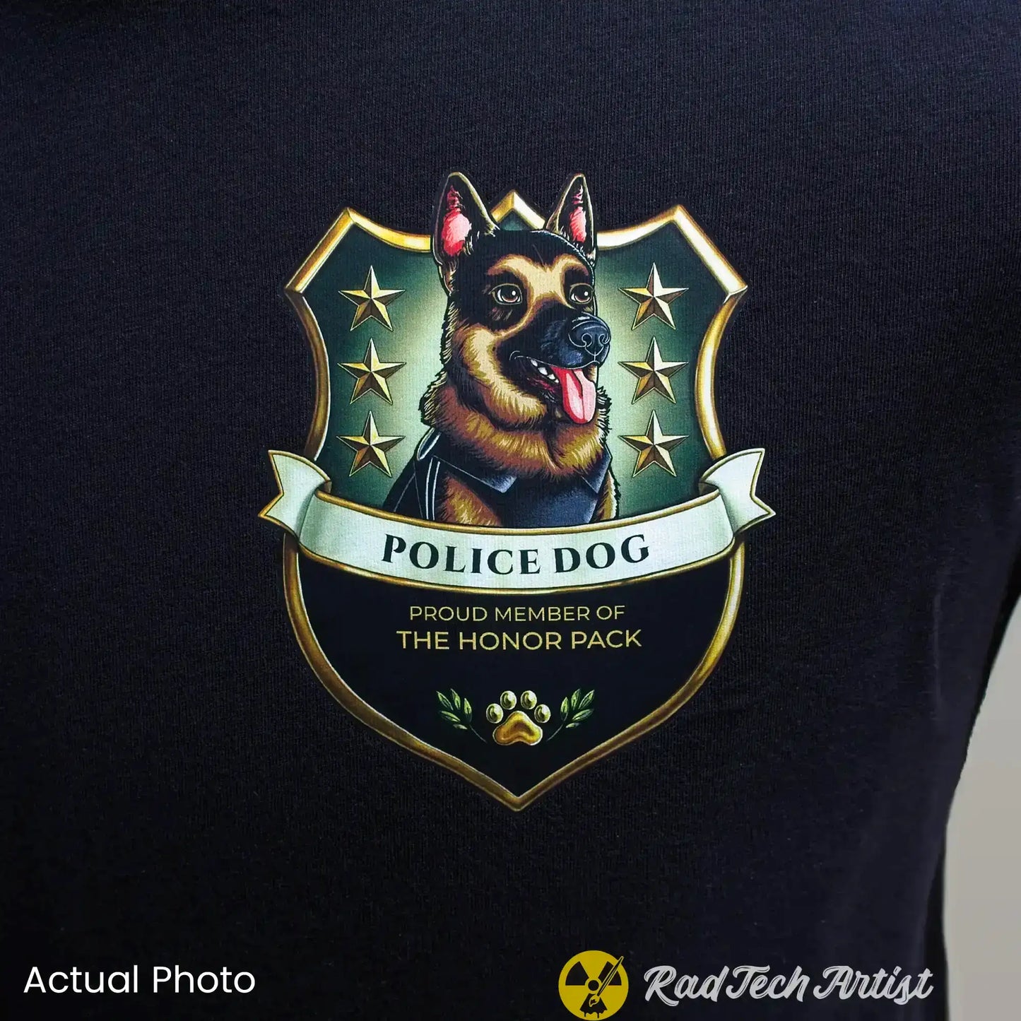 Close up shot of a black t-shirt with a German Shepherd police dog emblem and text on a dark background