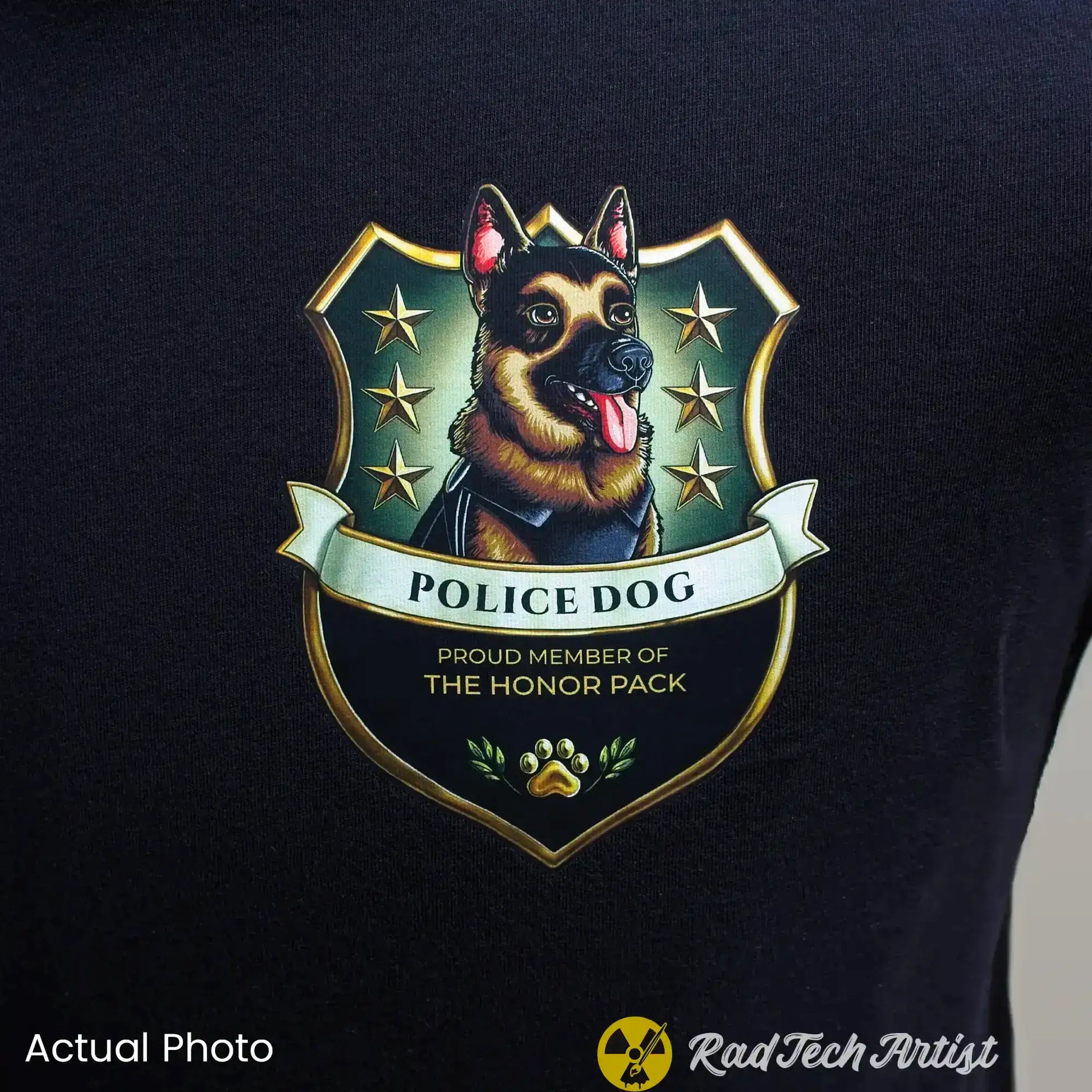 Close up shot of a black t-shirt with a German Shepherd police dog emblem and text on a dark background