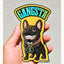 Hand holding a holographic vinyl sticker of a French Bulldog with a huge toothy grin, wearing a thick gold chain with a large dollar sign pendant. The sticker features bold, holographic "GANGSTA" text at the top and a bright yellow background. The holographic shine adds rainbow effects to the gold elements and lettering. "Rad Tech Artist" is printed in the bottom corner.