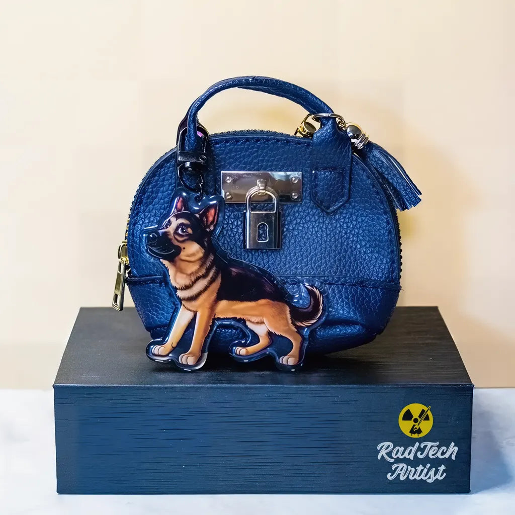 German Shepherd acrylic keychain attached to a blue handbag, showing scale and everyday use.