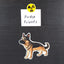 Magnet of a black and tan german Shepherd with 'Fridge Friends' text and radiation symbol above it on a black background.