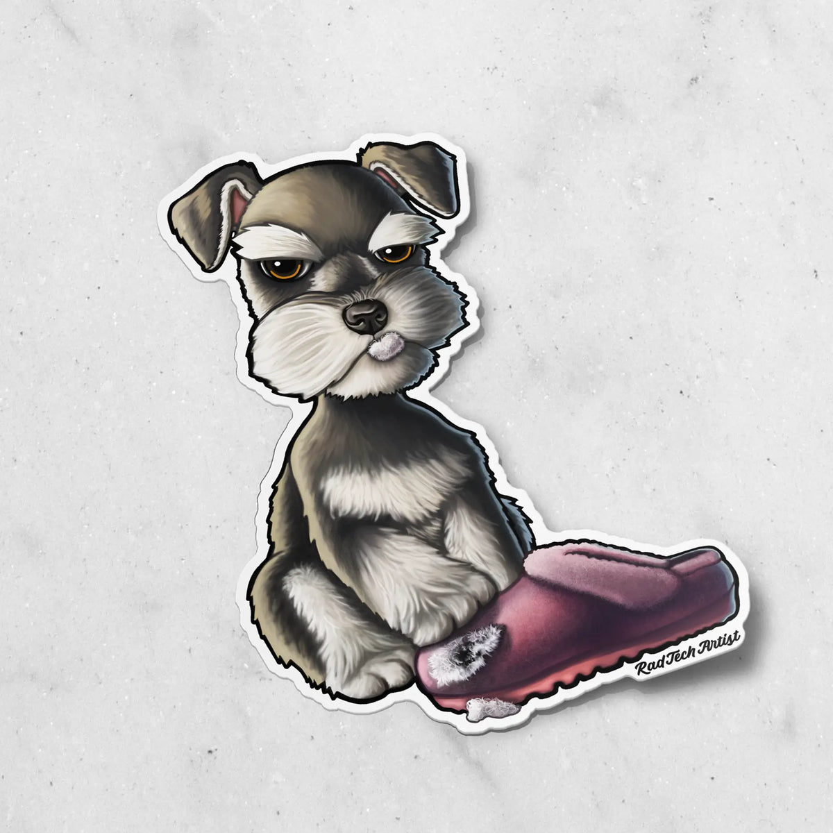 A die-cut sticker featuring a cartoon Schnauzer sitting next to a maroon slipper, set against a light gray marble-textured background. The artist's signature 'Rad Tech Artist' is visible in the bottom right corner of the sticker.