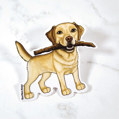 Sticker of a yellow Labrador Retriever with a stick on a marble surface