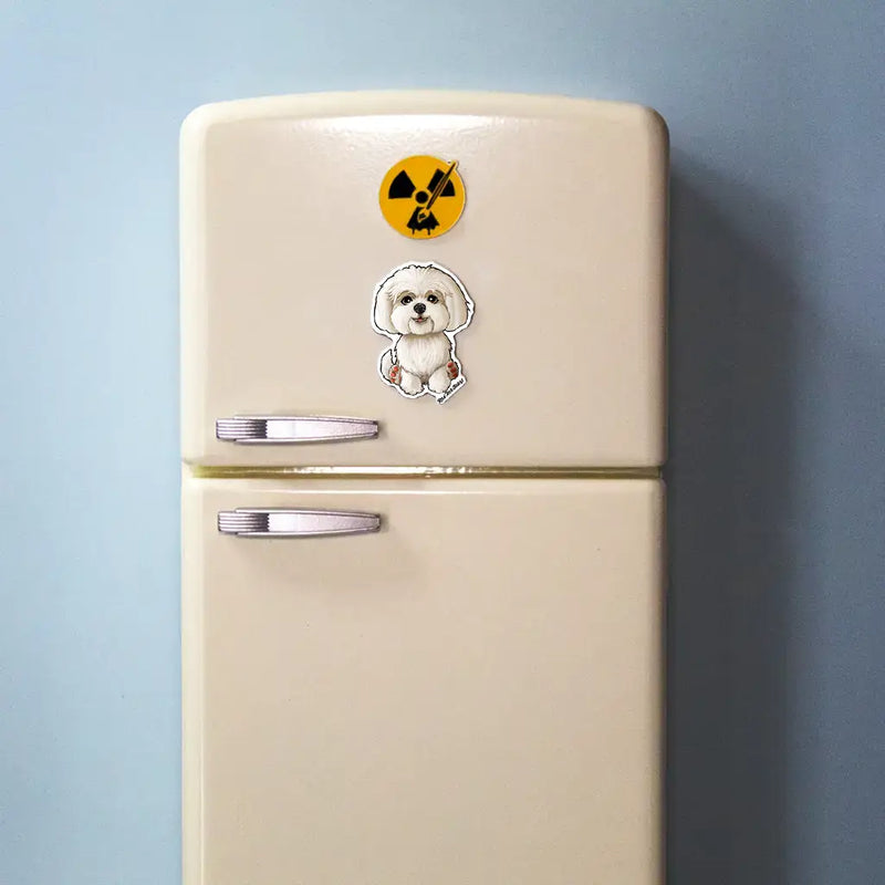 White Maltese dog magnet with fluffy coat displayed on a beige mini fridge with light blue background.