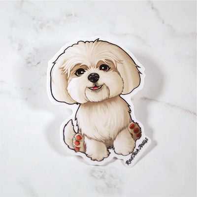 Sticker of a cartoon Maltese on a marble surface