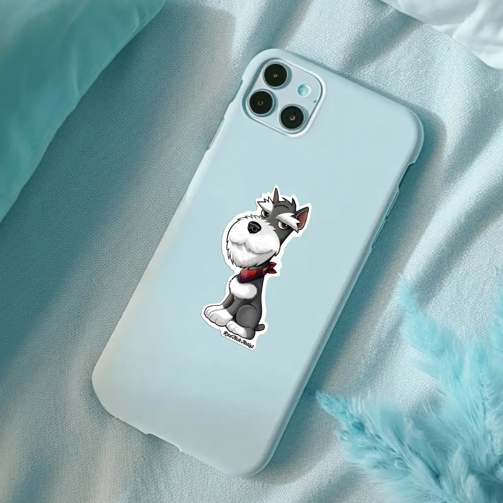 Actual photo of a salt and pepper Miniature Schnauzer sticker on the back of a light blue phone. The dog has a sly smile and wears a red bandana. The phone rests on soft fabric with teal accents in the corner, creating a cozy, stylish setting.