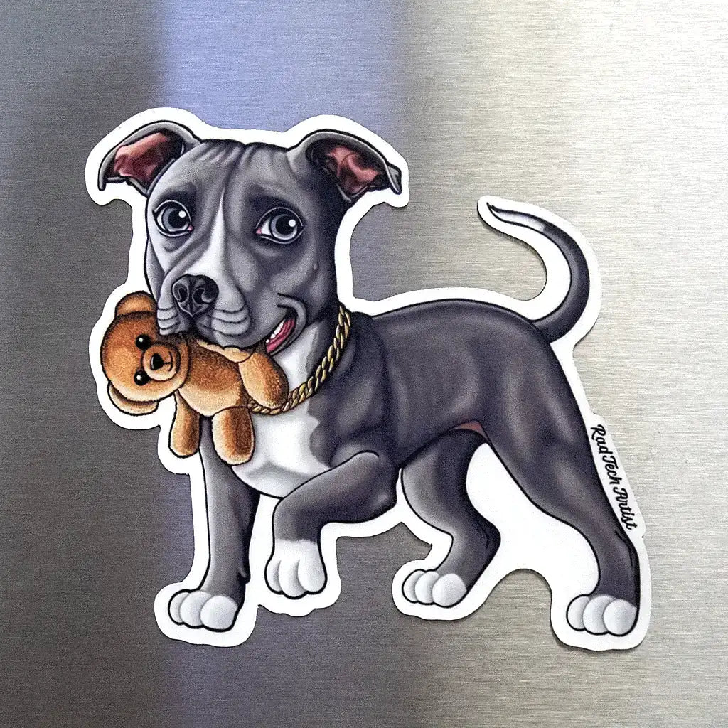 Blue-white Pit Bull dog magnet holding a teddy bear displayed on a stainless steel fridge surface.