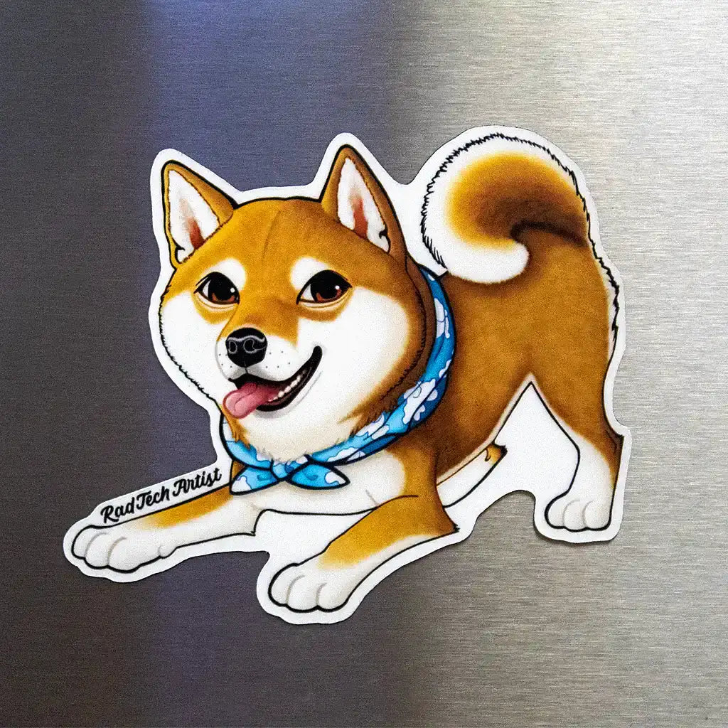 Shiba Inu dog magnet with red coat and blue bandana displayed on a stainless steel fridge surface.