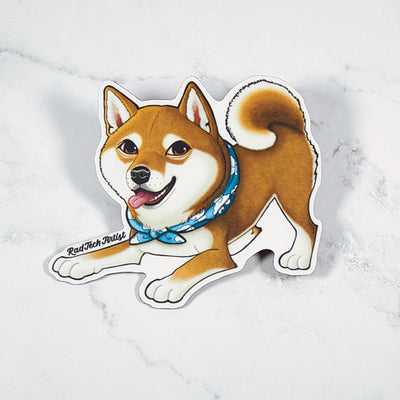 Magnet of a red Shiba Inu dog with a blue bandana on a marble background