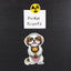 Magnet of a  gold and white Shih Tzu holding a toy lion with 'Fridge Friends' text and radiation symbol above it on a black background.