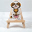 gold and white Shih Tzu sticker on a small wooden easel against a light gray background