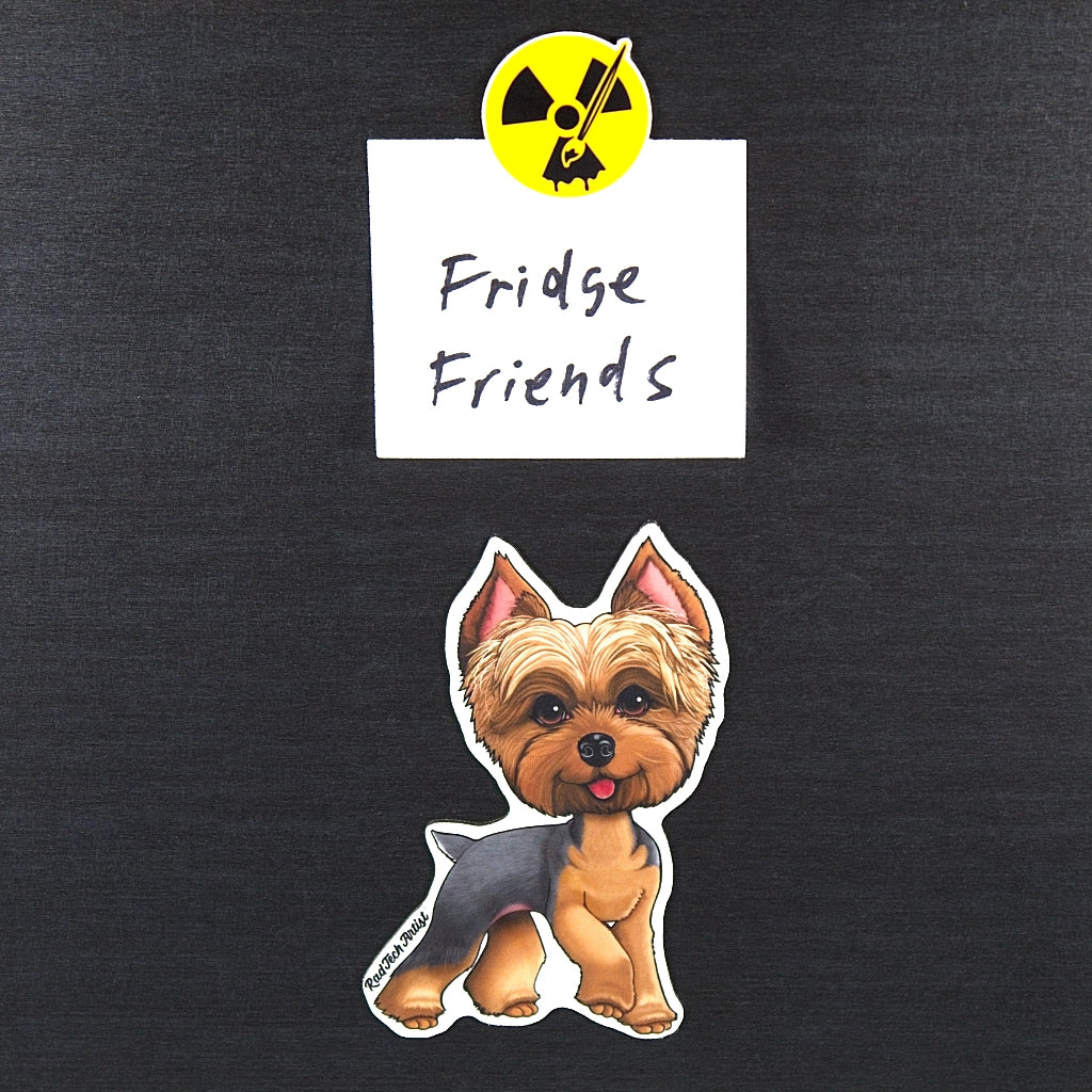 Gold and blue Yorkie magnet on a metal surface with a labeled 'Fridge Friends' on a black surface with a radiation symbol magnet