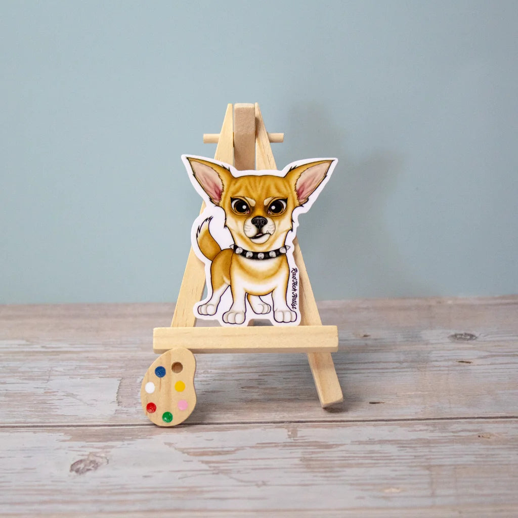 Vinyl sticker of a short-haired fawn Chihuahua with a spiked black collar, posed confidently on a mini easel – tough and tiny dog sticker with attitude.