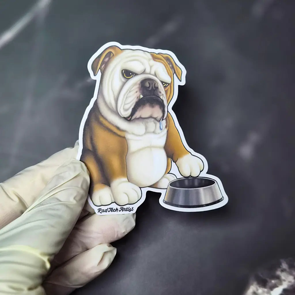  An English Bulldog vinyl sticker featuring a grumpy red-and-white bulldog tapping a metal food bowl held in a gloved hand over a dark marble background.