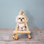 Vinyl sticker of a fluffy white Maltese sitting sweetly on a mini easel, with soft fur and a gentle smile – charming toy breed dog sticker with a calm expression.
